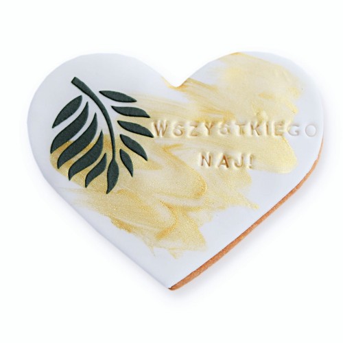 Maślane ciasteczko z białym lukrem i motywem roślinnym.