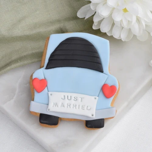 Ciastko lukrowane w kształcie garbusa tyłem z napisem Just Married.