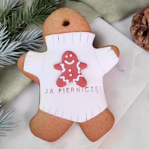 Piernikowy ludzik w sweterku z piernikowym ludzikiem ;) i śmiesznym napisem "Ja pierniczę!".